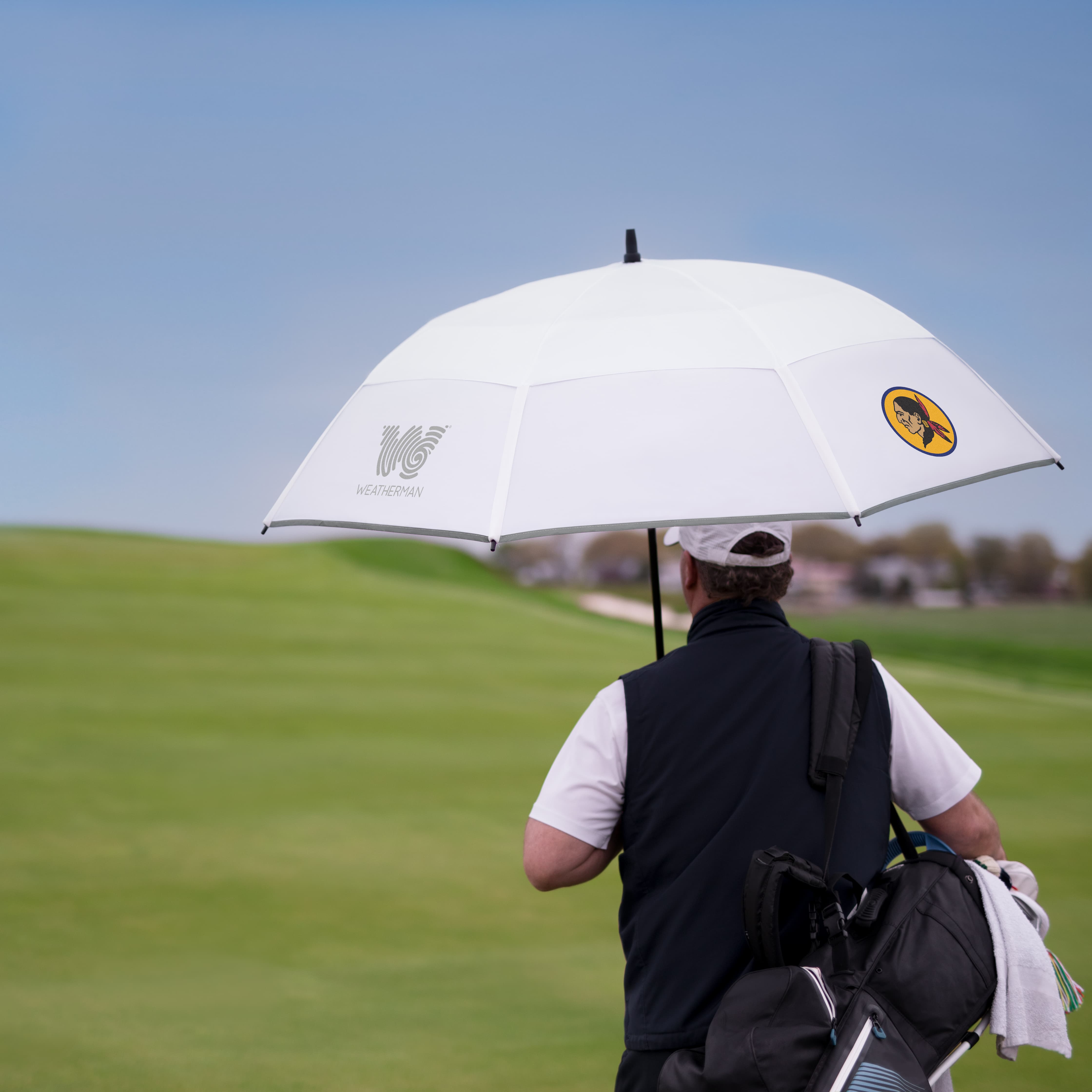 Person holding a Weatherman umbrella on a sunny day