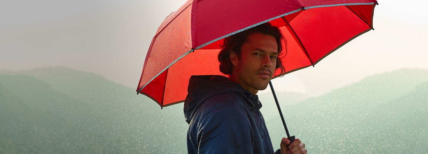 Man with red umbrella in the rain