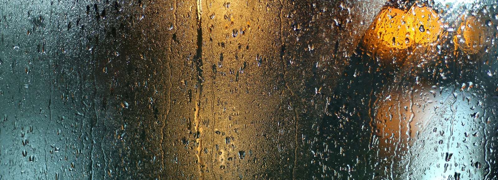 Raindrops falling, creating a wet surface effect