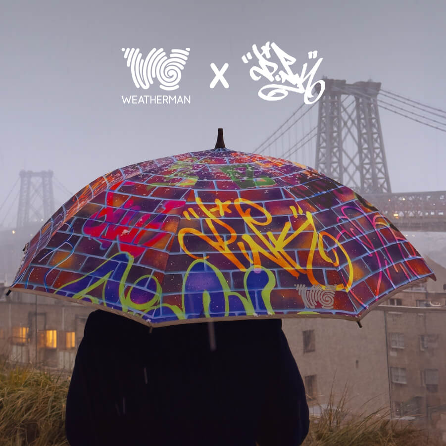 Person walking in New York City with Weatherman Stick Umbrella in Lady Pink design.